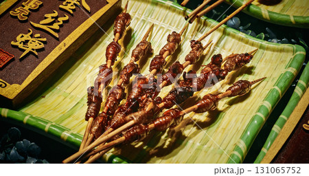 Chengdu, Sichuan, China. Insects On Sticks At Local Chinese Market. Various Cooked Insects Thread On Skewers. Crispy Insects Popular Sichuan Snack Cheap High Protein Street Food Low Fat. Cooked Bugs Chengdu, Sichuan, China. Insects On Sticks At Local Chinese Market. Various Cooked Insects Thread On Skewers. Crispy Insects Popular Sichuan Snack Cheap High Protein Street Food Low Fat. Cooked Bugs 131065752