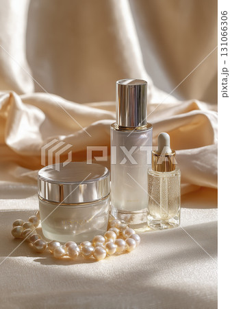 Elegant skincare products with pearl necklace on silky fabric, showcasing luxurious beauty routine and glowing skin 131066306