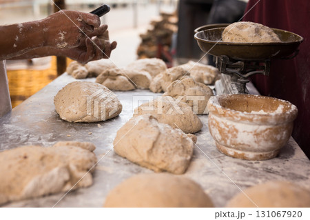Men's hands kneading yeast dough for baking bread on the table 131067920