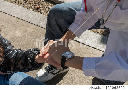 Doctor comforting patient by holding hands, offering support and empathy after bad news Doctor comforting patient by holding hands, offering support and empathy after bad news 131068263
