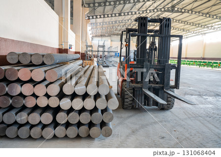 Forklift in Warehouse with Stacked Metal Rods 131068404