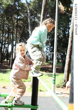 two pretty sisters twins playing outside, lifestyle people concept 131068679