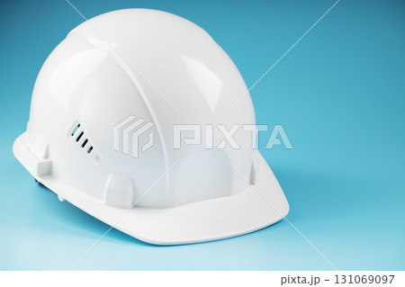 Construction worker's safety helmet white on blue background 131069097