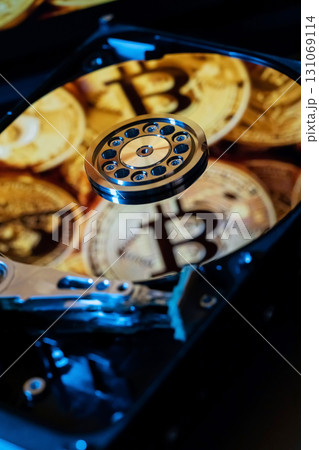 A hard drive decorated with gold bitcoin symbols 131069114