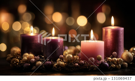 Christmas candles glowing with festive wreath and golden holiday bokeh lights 131069437
