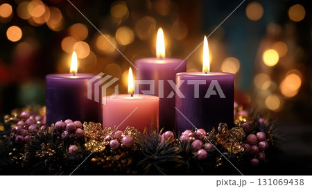 Christmas candles glowing with festive wreath and golden holiday bokeh lights 131069438