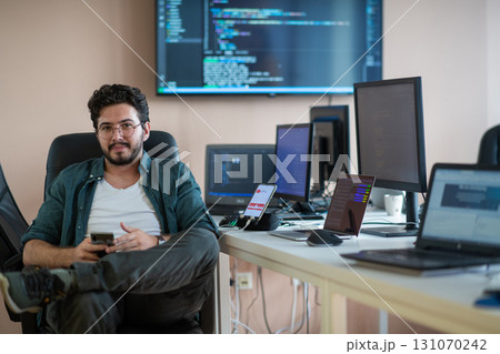 A programmer diligently testing smartphone applications  131070242
