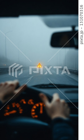 Driving in Fog Dashboard View with Warning Sign on Road Ahead 131070316