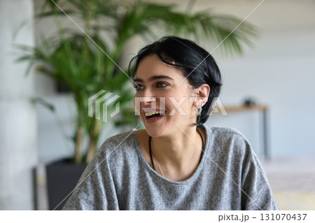 A close up portrait of a young businesswoman engaged in a professional meeting, confidently discussing ideas and strategies with her colleagues 131070437