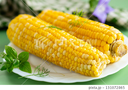 Hot corn cobs with greens fresh homemade side dish Hot corn cobs with greens fresh homemade side dish 131072865