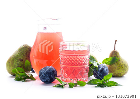 Refreshing fruit drink with plums and pears on a white background Refreshing fruit drink with plums and pears on a white background 131072901