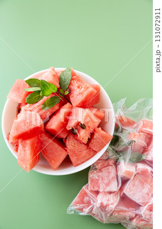 Summer concept with fresh and frozen watermelon fruit cubes 131072911