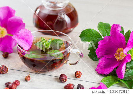 Aesthetic serving of tea with rosehip, petals and mint greens Aesthetic serving of tea with rosehip, petals and mint greens 131072914