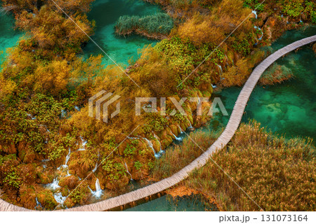 Aerial top down view of a wooden walkway in Plitvice Lakes National Park with small waterfalls 131073164