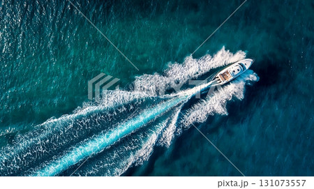 White Motorboat Cruising Turquoise Ocean Water, Aerial View of Boat and Wake 131073557