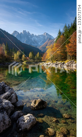 Crystal Clear Lake Reflecting Autumn Trees and Snow Capped Mountains Crystal Clear Lake Reflecting Autumn Trees and Snow Capped Mountains 131073754