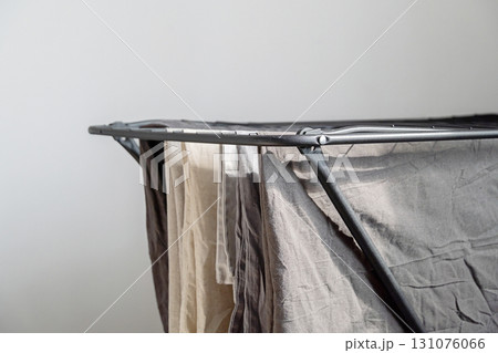 Clothes drying rack with various clothing hung. Domestic laundry and housework concept. 131076066
