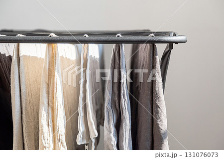 Laundry on drying rack indoors with natural light. Laundry on drying rack indoors with natural light. 131076073
