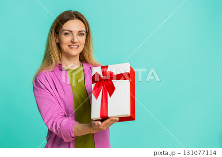 Woman opening gift box with excitement showing joy surprise celebration moment with cheerful smile 131077114