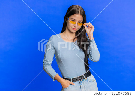 Caucasian young stylish cool woman wearing yellow sunglasses, charming friendly playful smile 131077583