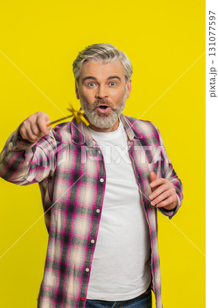 Magician witch Caucasian man gesturing with magic wand making wish come true, casting magician spell Magician witch Caucasian man gesturing with magic wand making wish come true, casting magician spell 131077597