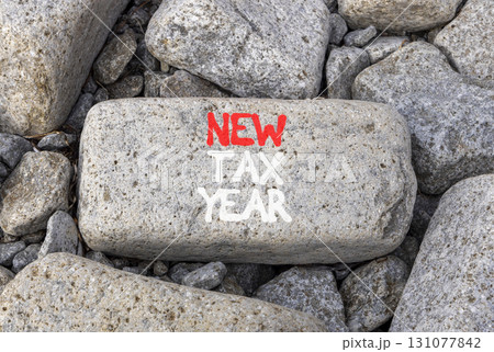 New tax year symbol. Concept words New tax year on beautiful grey stone. Beautiful grey stones background. Business new tax year concept. Copy space. New tax year symbol. Concept words New tax year on beautiful grey stone. Beautiful grey stones background. Business new tax year concept. Copy space. 131077842