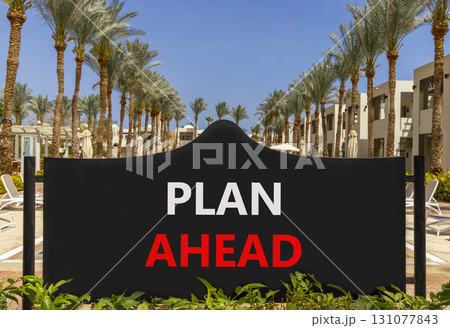 Plan ahead symbol. Concept word Plan ahead on beautiful black road sign. Beautiful palm trees and blue sky background. Business plan ahead concept. Copy space. Plan ahead symbol. Concept word Plan ahead on beautiful black road sign. Beautiful palm trees and blue sky background. Business plan ahead concept. Copy space. 131077843