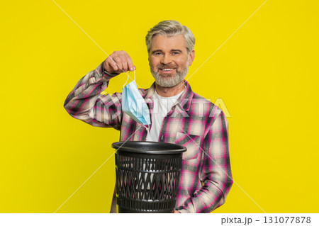 Mature man taking off medical mask flu treatment cure ending of pandemic quarantine disease recover Mature man taking off medical mask flu treatment cure ending of pandemic quarantine disease recover 131077878
