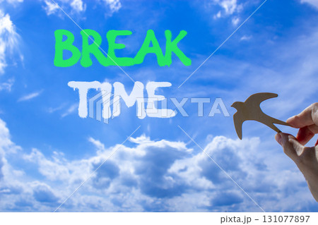 Break time symbol. Concept word Break time on beautiful blue sky. Businessman's hand with wooden bird. Beautiful blue sky and cloud background. Business break time concept. Copy space. 131077897