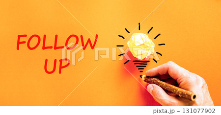 Follow up symbol. Concept word Follow up on beautiful orange paper. Businessman's hand. Light bulb icon. Beautiful orange paper background. Business follow up concept. Copy space. Follow up symbol. Concept word Follow up on beautiful orange paper. Businessman's hand. Light bulb icon. Beautiful orange paper background. Business follow up concept. Copy space. 131077902