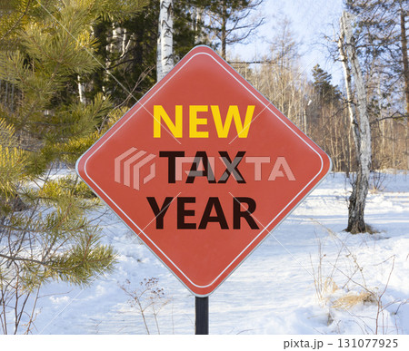 New tax year symbol. Concept words New tax year on beautiful red road sign. Beautiful snow forest background. Business new tax year concept. Copy space. 131077925