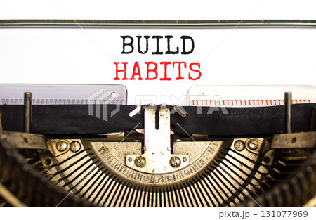 Build habits symbol. Concept word Build habits typed on beautiful old retro typewriter. Beautiful white paper background. Business build habits concept. Copy space. Build habits symbol. Concept word Build habits typed on beautiful old retro typewriter. Beautiful white paper background. Business build habits concept. Copy space. 131077969