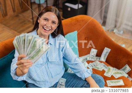 Successful happy rich business woman counting money cheering up with high profits lottery game win Successful happy rich business woman counting money cheering up with high profits lottery game win 131077985