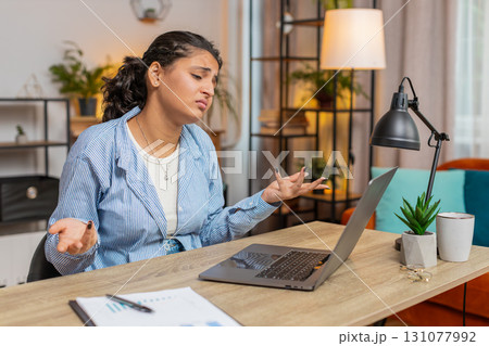 Upset furious woman freelancer using laptop working at home office having nervous breakdown at work 131077992