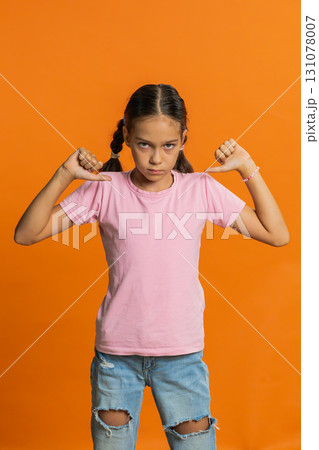 Upset preteen child girl showing thumbs down, dislike bad work, disapproval, dissatisfied feedback Upset preteen child girl showing thumbs down, dislike bad work, disapproval, dissatisfied feedback 131078007