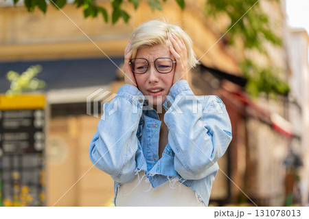 Sad unhappy young woman thinks over life concerns, suffers from unfair situation on city street Sad unhappy young woman thinks over life concerns, suffers from unfair situation on city street 131078013