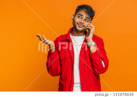 Disinterested tired Indian man having annoyed boring talk on smartphone online conversation, quarrel 131078039