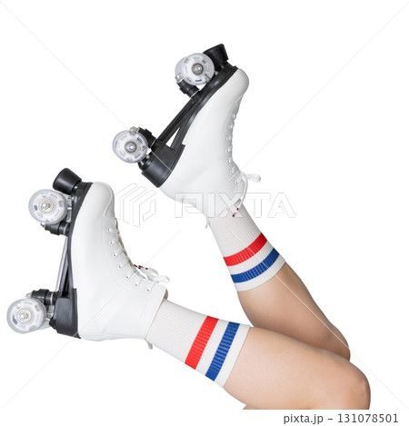 Female legs with white roller skates and striped socks raised up 131078501