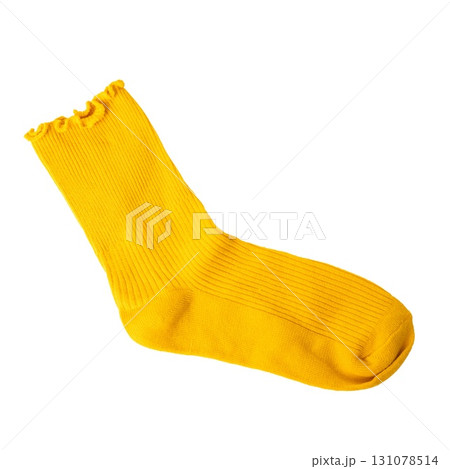 Single bright yellow sock with ruffled edge on black background 131078514