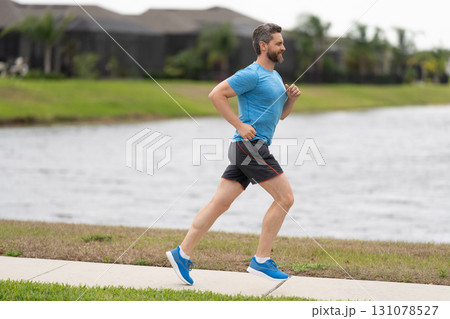 Sport fit runner jogging. Jogging activity. Running man run down the river. Jogging man enjoy the freedom of running outdoor. Man runner running training during the run. Healthy lifestyle Sport fit runner jogging. Jogging activity. Running man run down the river. Jogging man enjoy the freedom of running outdoor. Man runner running training during the run. Healthy lifestyle 131078527