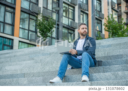 freelance man with laptop outdoor, copy space. freelance man in the street. freelance man 131078602