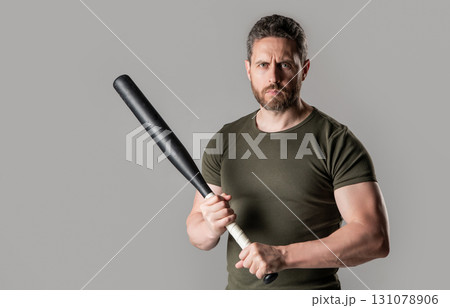 angry man threatening, copy space. angry man express anger with bat isolated on grey 131078906