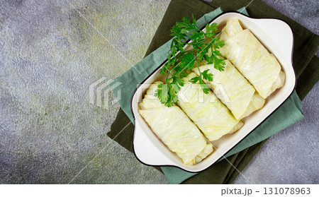 raw cabbage rolls, not cooked, with minced meat, top view, without people, in the spotlight. 131078963