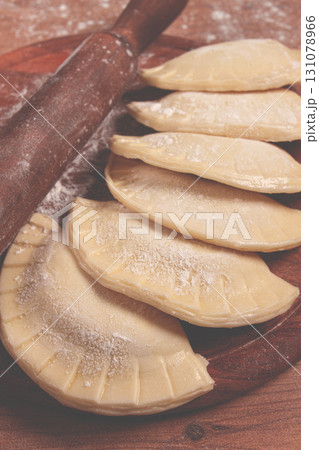 raw chebureks, mini, on a cutting board, wooden table, close-up, no people, raw chebureks, mini, on a cutting board, wooden table, close-up, no people, 131078966