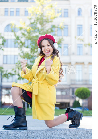 Positive influence of music. Childhood and teenage music taste. Little girl listening music enjoy favorite song. Girl with headphones urban background. Child girl french style outfit enjoying music 131079579