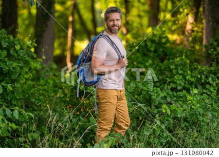 Trekking lifestyle. Man hiking in countryside. Hispanic man forest. Hiker with backpack hiking in forest. Male hiker walking in forest. Man traveler hike with backpack. Hiker adventure. Forest hike Trekking lifestyle. Man hiking in countryside. Hispanic man forest. Hiker with backpack hiking in forest. Male hiker walking in forest. Man traveler hike with backpack. Hiker adventure. Forest hike 131080042