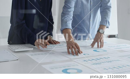 Professional business team analyzing financial reports, sharing insights and planning strategic decisions in modern office Professional business team analyzing financial reports, sharing insights and planning strategic decisions in modern office 131080095