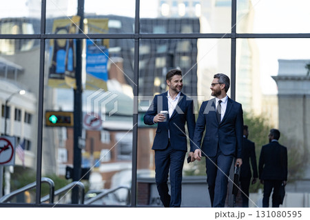 Businessmen go to work. Business talking. Two businessmen in elegant business suit. Walking colleague. Colleague and friends. Two successful business men walking outdoor. Business district 131080595