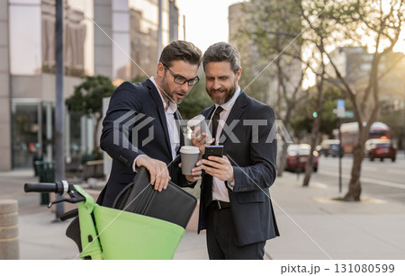 Businessmen in suit with phone. Online working. Businessmen checking business chat. Business men freelancing outdoor. Business online. Men working on phone. Businessmen working online. Check email Businessmen in suit with phone. Online working. Businessmen checking business chat. Business men freelancing outdoor. Business online. Men working on phone. Businessmen working online. Check email 131080599