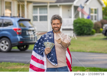 Hispanic man and USA flag. Paying tax in America. Value added tax. Taxation system. Patriotic man point finger. Man with American flag and dollar money. Inflation concept. American tax policy Hispanic man and USA flag. Paying tax in America. Value added tax. Taxation system. Patriotic man point finger. Man with American flag and dollar money. Inflation concept. American tax policy 131080716